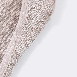 Detailed view of women knit yoga socks with luxury monogram pattern soft cotton fabric texture