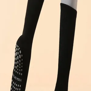 Nahaufnahme schwarzer Yoga-Grip-Socken mit Anti-Rutsch-Noppen an der Sohle für Pilates.