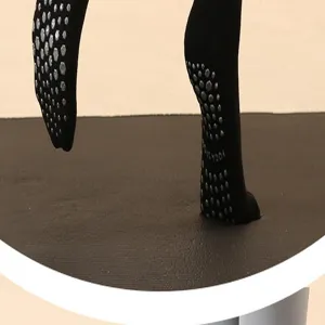 Detailaufnahme schwarzer Anti-Rutsch-Yogasocken mit silbernen Noppen auf Yogamatte.
