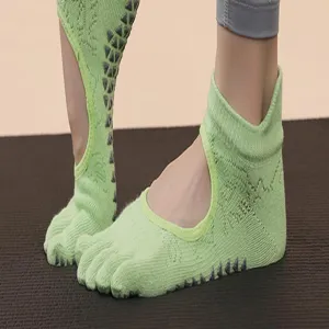 Close-up detail of women's anti-slip five-toe yoga socks with breathable cutout and grip sole.