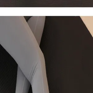 Close-up detail of grey athletic leggings showing smooth fabric and neat stitching.