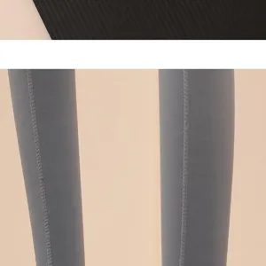 Grey yoga pants or long socks detail view showing neat vertical seam and stretchy fabric texture.