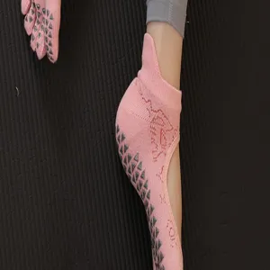 Pink non-slip yoga socks detail view, open instep pilates grip sock close-up shot.