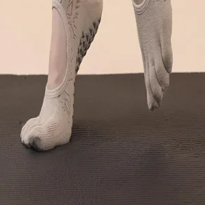 Non-slip five toe yoga socks for women, breathable cotton pilates athletic footwear detail view.