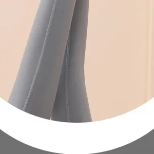 Grey athletic yoga leggings close-up detail showing premium knit fabric and neat stitching.