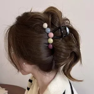 Detailed view of the colorful bead hair claw clip, showing its stylish design for women's hair.