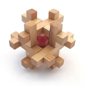 Wooden interlocking puzzle detail showing traditional mortise structure with a red ball.