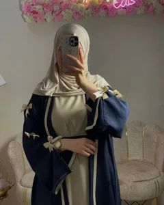 Elegant long abaya cardigan with bow details, chic contrast trim Muslim maxi dress outfit.