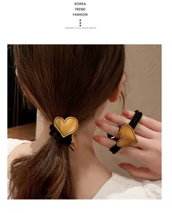 Minimalist gold heart hair tie, elegant black elastic hair band for women daily wear.