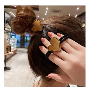 Stylish heart-shaped hair tie with elegant leather texture, perfect for cute ponytails.