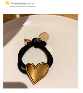 Chic black hair rope featuring a trendy gold heart metal pendant for daily sweet styling.