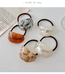 Detailed view of fashionable resin hair ties with geometric design, perfect for elegant ponytails.