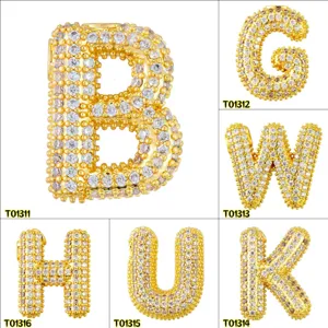 Detail view of gold plated bubble letter pendant, sparkling micro paved cubic zirconia charms.