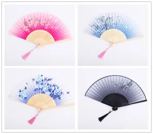 Traditional Chinese silk folding fans set with delicate floral patterns and tassels.