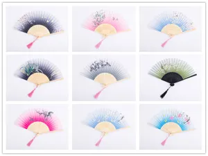 Close-up detail of traditional Chinese style folding fans with floral patterns and tassels.