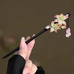 Close-up detail of the traditional Chinese style hair stick with floral accents and tassels.