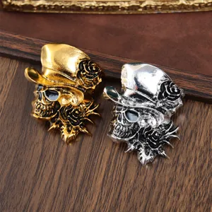 Detailed close-up view of gothic skull and rose brooches in gold and silver alloy finish.