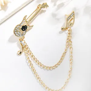Gold alloy rhinestone guitar and musical note brooch detail shot, perfect for dress decor.
