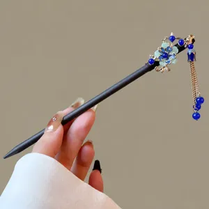Vintage Chinese wooden hair stick with blue tassel, elegant hair accessory for women.
