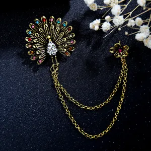 Vintage palace style peacock brooch with double chains and rhinestones for elegant dresses.