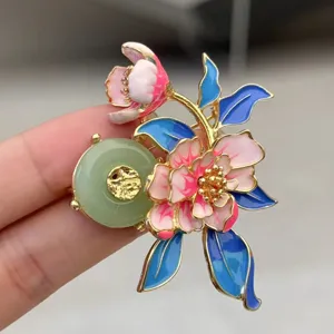 Detailed shot of Chinese style peony flower brooch featuring elegant enamel and jade disc.