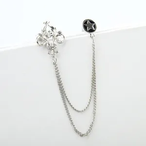 Retro court style silver brooch with double chains, gothic lily crest and star pendant detail.