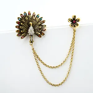Vintage peacock and flower double pin brooch with chain, ornate rhinestone crystal detail.