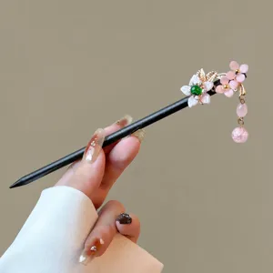 Chinese vintage wooden hair stick with pink floral tassels, elegant hair accessory for women.