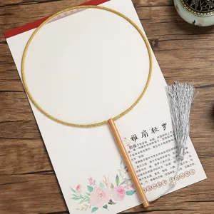 Detail shot of a blank round silk hand fan with wooden handle and elegant silver tassel.