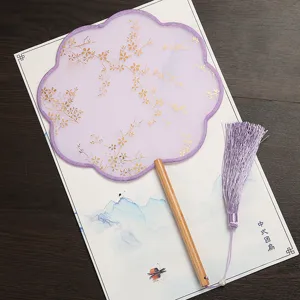 Chinese round palace fan with purple mesh, gold floral print, wooden handle & tassel.