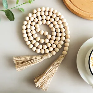 Natural wood bead garland with jute tassels, pastoral style home decor hanging accessory.