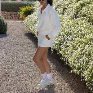 Women white polo sweatshirt and tennis skirt set, casual long sleeve athletic outfit for daily wear.
