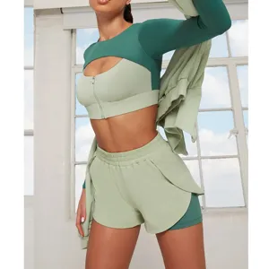 Green activewear set for women, featuring zip sports bra, cropped top, and gym shorts for yoga.