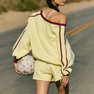 Detail view of casual athletic sweatshirt and high-waisted shorts set in butter yellow.