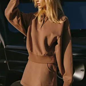Casual sports set featuring a polo collar long sleeve sweatshirt and high waist tennis skirt.