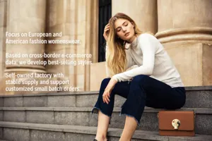 Outdoor street style detail view featuring a model wearing casual knitwear and denim on steps.