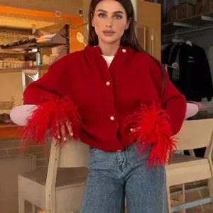 Stylish red knitted cardigan featuring chic feather cuffs and elegant button closure.