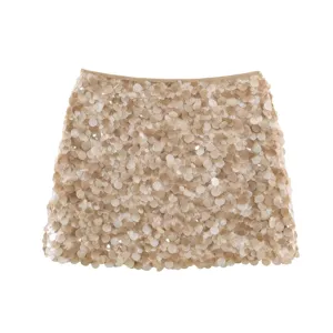 Detailed shot of stylish champagne sequin high waist mini skirt, sparkling clubwear.