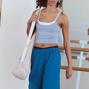 Detailed view of women's layered contrast sports tank top, breathable fitness yoga wear.