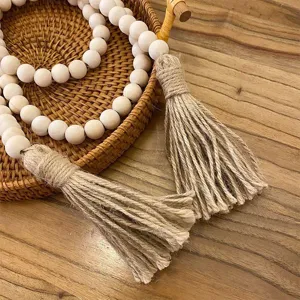 Wooden bead tassel string detail shot, natural texture, boho home decor style close-up.