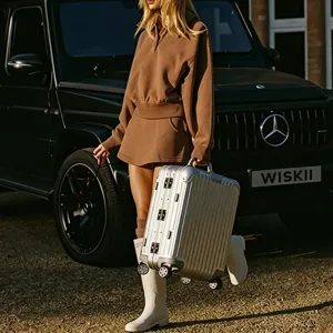 Casual brown polo sweatshirt and high waist pleated tennis skirt sporty outfit for women.