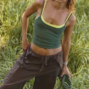 Detailed view of the layered contrast color sports tank top worn outdoors with cargo pants.