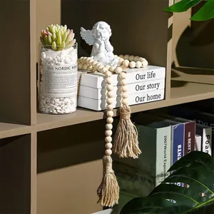 Close-up of pastoral wooden bead garland with jute tassels for chic home shelf decor.