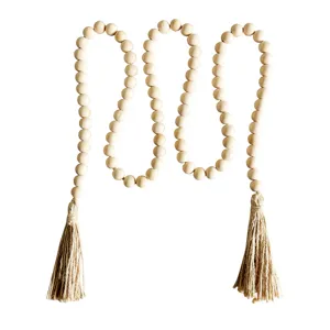 Rustic wooden bead garland with jute tassels, natural farmhouse home decor and wall hanging.