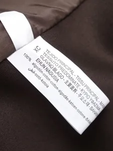 Detailed view of the garment's interior wash label showing 100% cotton fabric composition.