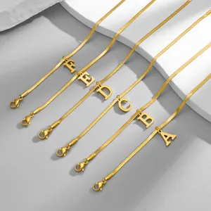 Close-up detail of gold-plated snake chain necklace featuring elegant alphabet letter pendants.