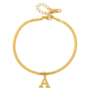 Detailed closeup view of gold snake chain necklace featuring letter A pendant and K18 tag.