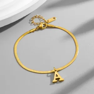 Gold snake chain bracelet with letter A pendant, minimalist elegant jewelry accessory detail shot.