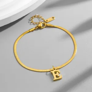 Gold initial E snake chain bracelet detail shot, luxury stainless steel jewelry gift.