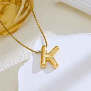 Detail shot of the gold 3D bubble letter K pendant necklace, showcasing fine metallic texture.
